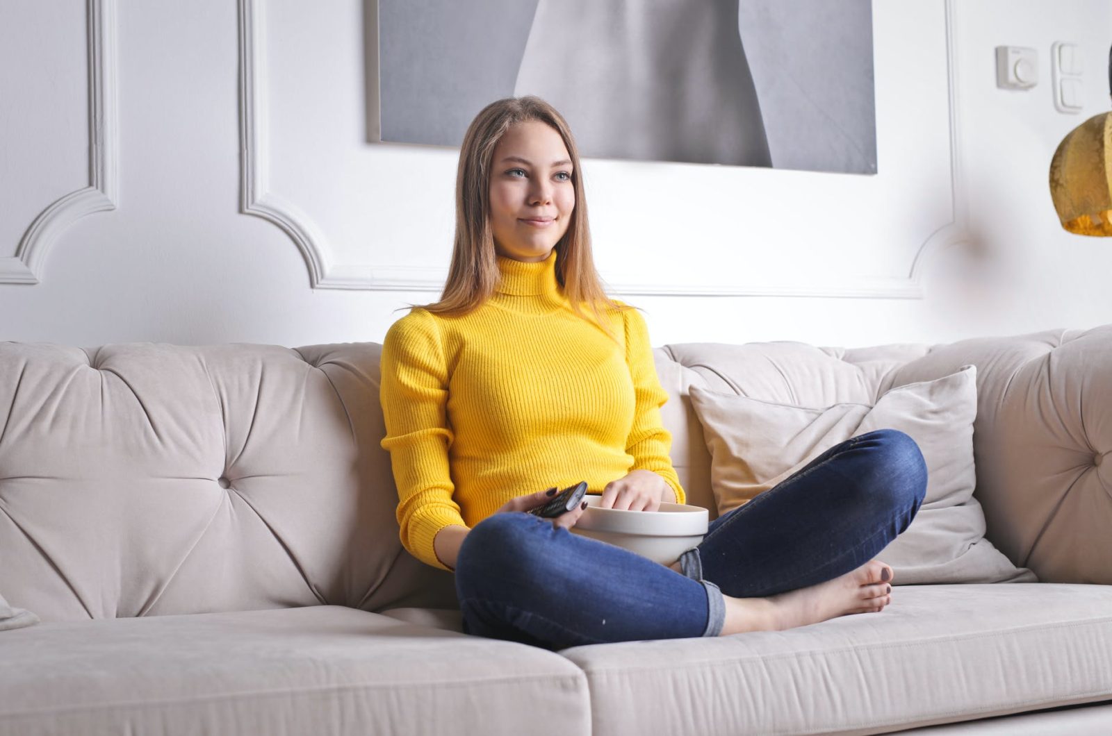 cheerful woman watching tv at home